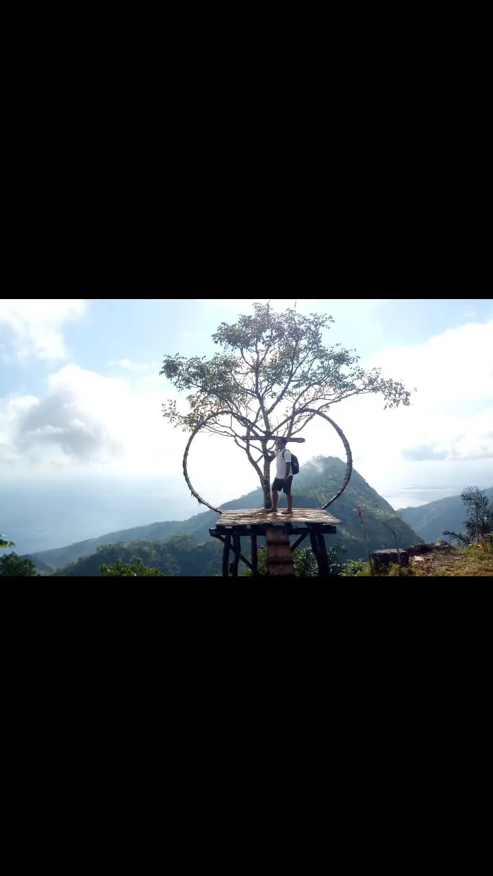 Heart-shaped tree swing photo spot at Lahangan Sweet with sea view
