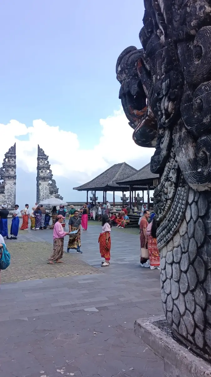 Visitors in traditional sarongs inside the Lempuyang Temple courtyard