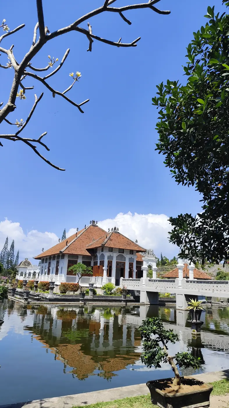 Main pavilion of Taman Ujung Water Palace reflected in the pond